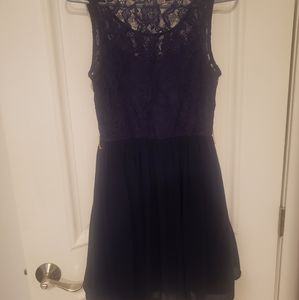 Dark blue cocktail dress with lace underskirt.